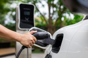 Person charging car with commercial EV charger