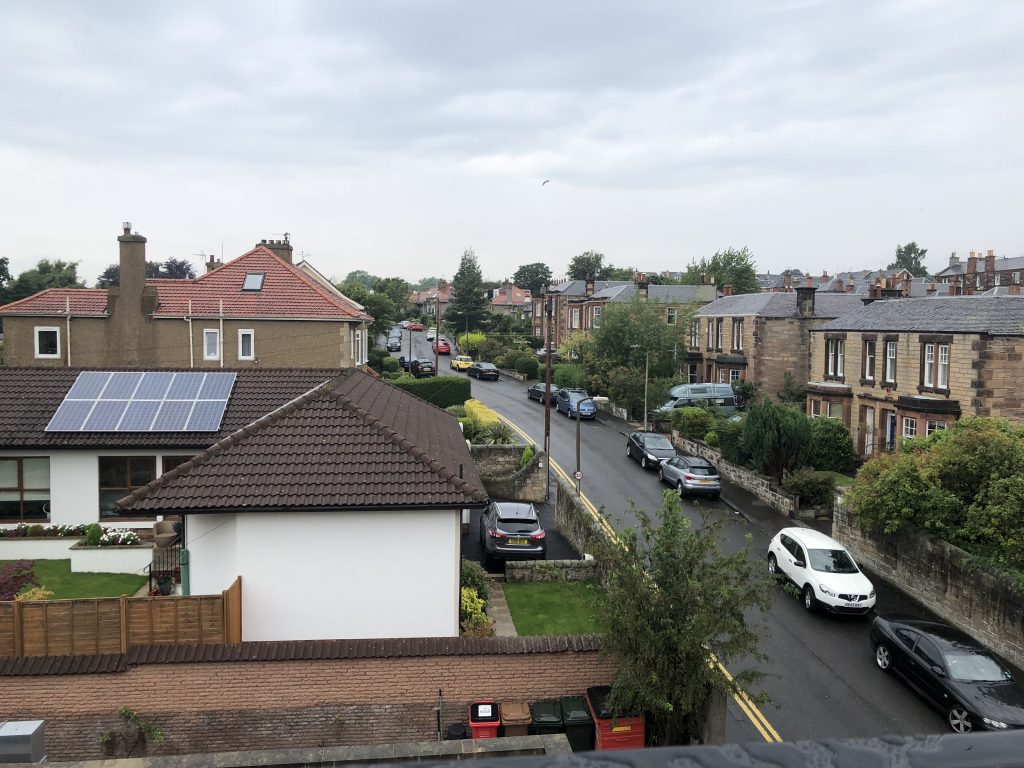 View of solar panels across residential street