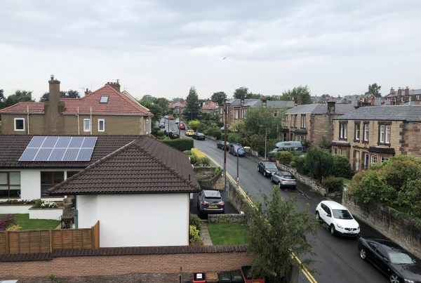 View of solar panels across residential street
