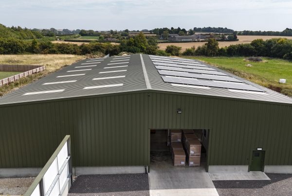 view of warehouse entrance with solar panels on roof